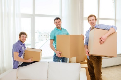 Professional movers handling packed boxes