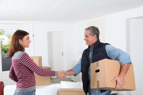 Professional man with van unloading furniture in Chiswick